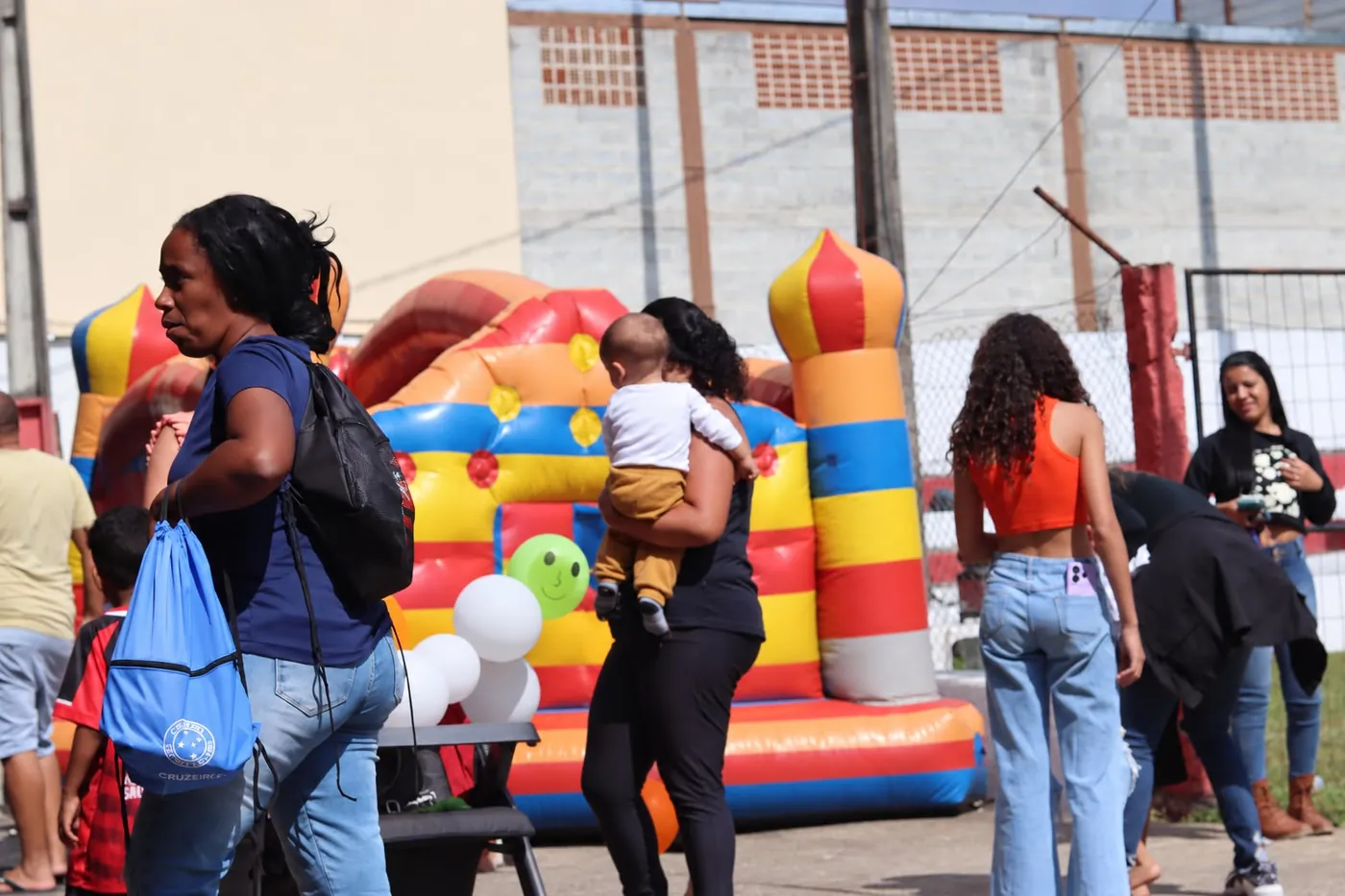 Familias y vecinos recorren una jornada del club, con un castillo inflable de fondo